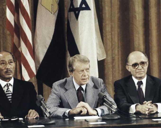 President Carter, center, is flanked by Egyptian President Anwar Sadat and Israeli Prime Minister Menachem Begin as they face newsmen at the conclusion of their Middle East peace talks at Camp David in Maryland in September 1978.