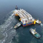 Special pontoons are being used to transport the tunnel elements to the correct location and to immerse them