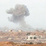 Explosion cloud over destroyed city