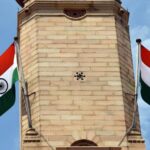 Indian national flags flying on brick monument