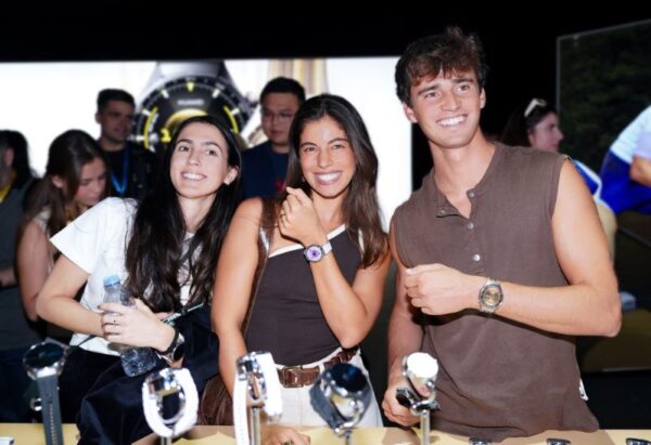 People showcasing watches at a product event