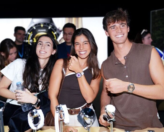 People showcasing watches at a product event
