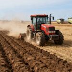 Tractor plowing field