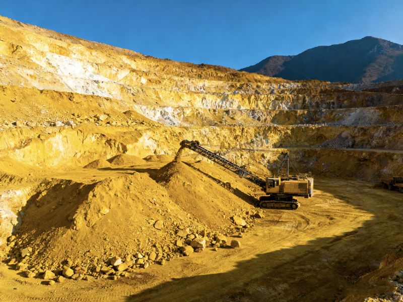 Large mining machine working in golden open-pit mine