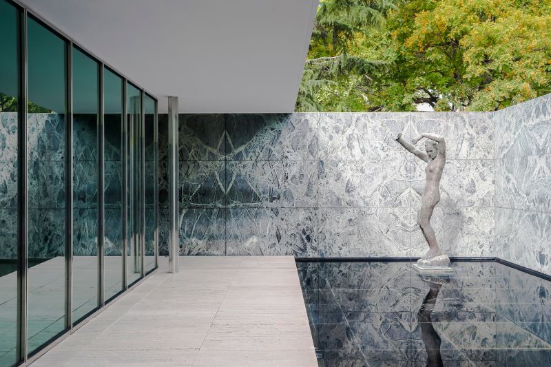 Barcelona pavilion interior with marble walls and statue