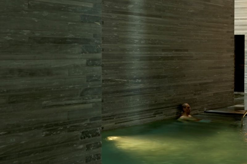 Thermal bath pool at vals spa with dark stone walls