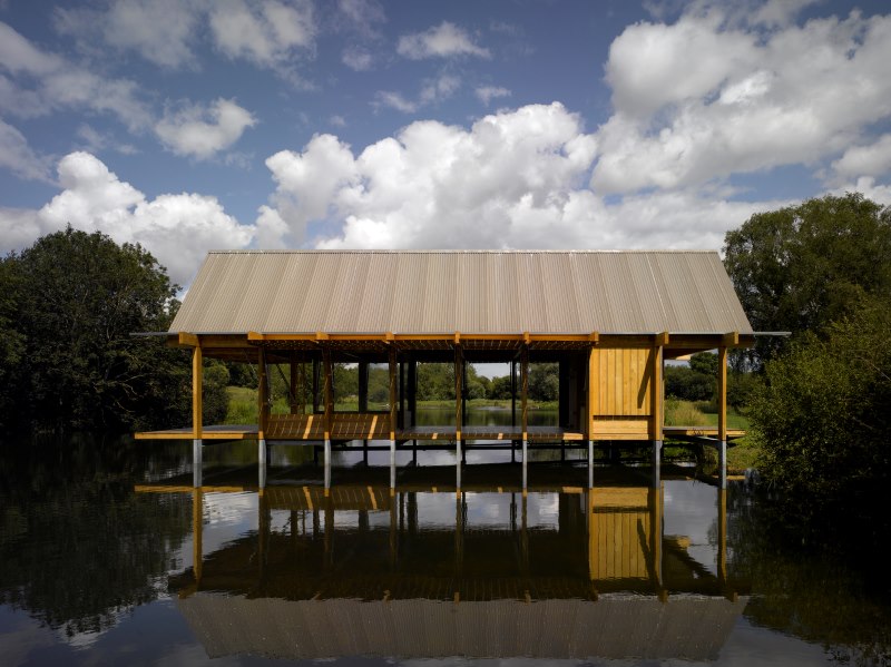 Wooden floating pavilion over calm lake